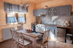 a kitchen with a table and chairs in a room at Domek Luna Wilcza Zagroda in Kudowa-Zdrój