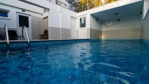 a swimming pool with blue water in a building at Lavanda 3 in Njivice