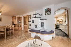 a kitchen and living room with a bed in the middle at Alpenchalet Mitterlechner in Bad Hofgastein