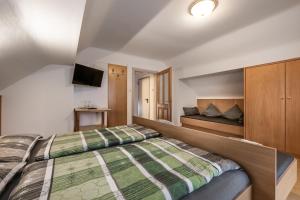 a bedroom with a bed and a television in it at Alpenchalet Mitterlechner in Bad Hofgastein