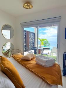 a bedroom with a large bed with a view of the ocean at The Black Palm in Philipsburg +108 photos