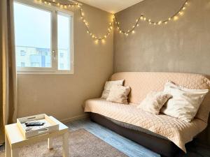 a bedroom with a bed with lights on the wall at Vacances à la mer - studio in Calais