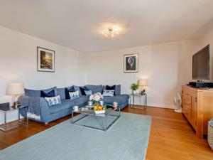 a living room with a blue couch and a tv at 2 Bed in West Bay oc-dc065 in West Bay