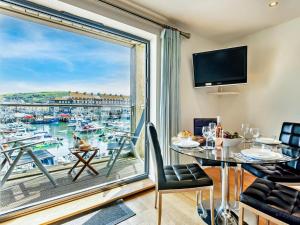 a dining room with a view of a marina at 2 Bed in West Bay oc-dc065 in West Bay