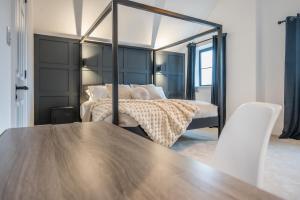 a bedroom with a bed with a large mirror at No 4 The Halesworth in Halesworth