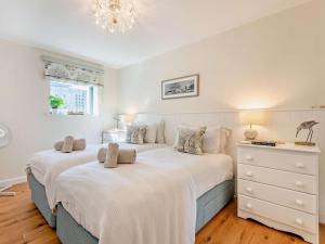 a bedroom with two beds and a dresser at 2 Bed in West Bay oc-dc065 in West Bay