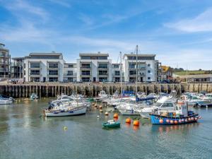 a group of boats docked in a harbor with buildings at 2 Bed in West Bay oc-dc065 in West Bay