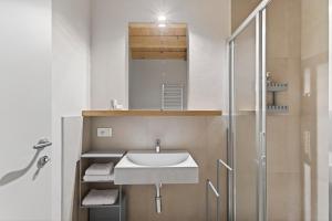 a bathroom with a sink and a shower at Foresteria Monastero B&B in Mandello del Lario