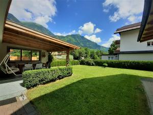 a yard with a patio and a house at Alpenchalet Mitterlechner in Bad Hofgastein