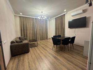 a living room with a table and chairs and a couch at Elen Apartment Goris in Goris