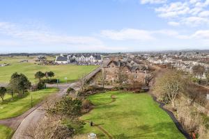an aerial view of a town with houses and a green field at Birdies Nest in Carnoustie