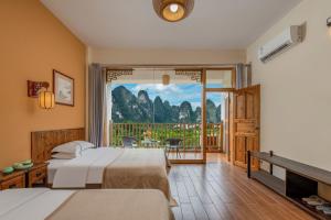 a hotel room with two beds and a balcony at Serenity Inn in Gaotian