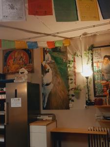 a kitchen with a refrigerator and a painting on the wall at Santander Central Hostel in Santander