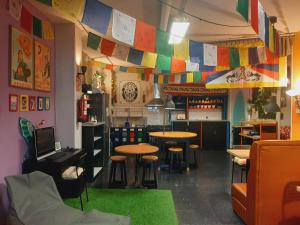 a restaurant with tables and chairs and a colorful ceiling at Santander Central Hostel in Santander