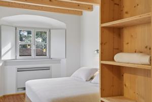 a bedroom with two beds and a window at Foresteria Monastero B&B in Mandello del Lario +63 photos