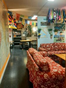 a waiting room with couches and a table in a restaurant at Santander Central Hostel in Santander +96 photos