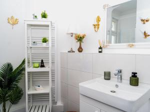 a white bathroom with a sink and a mirror at Altstadt Geverdes 3 in Lübeck +42 photos