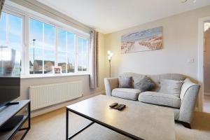 a living room with a couch and a coffee table at Folly Lodge in Barnsley