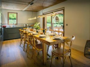 a dining room with a wooden table and chairs at Chalet Frontflip - OVO Network in La Clusaz