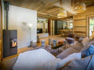 a living room with a couch and a fireplace at Chalet Frontflip - OVO Network in La Clusaz