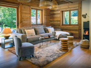 a living room with a couch and a fireplace at Chalet Frontflip - OVO Network in La Clusaz