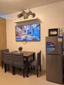 a dining room with a table and a refrigerator at Shore Residences TowerA in Manila
