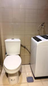 a bathroom with a white toilet and a sink at Shore Residences TowerA in Manila +4 photos