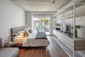 a bedroom with a large bed and a balcony at Gava Waterman Milna Resort – All Inclusive in Milna +44 photos