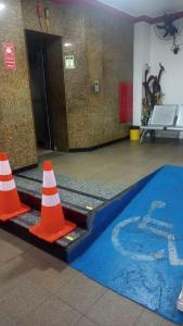 two orange traffic cones next to a swimming pool at Suíte panorama histórico in Manaus