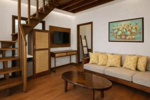 a living room with a couch and a table at JungleNest Resort in General Luna