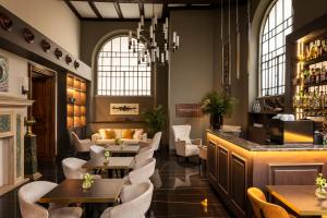 a restaurant with tables and chairs and a bar at Hotel Viminale in Rome