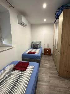 a room with two beds and a cabinet in it at Villa Erwin with heated pool in Imotski +77 photos