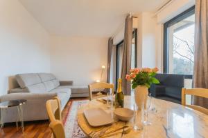 a living room with a table and a couch at Lara home in Campione dʼItalia