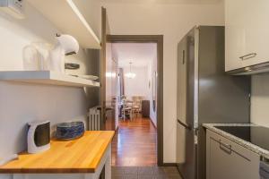 a kitchen with a wooden counter top in a room at Lara home in Campione dʼItalia +19 photos