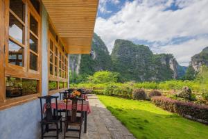 a table and chairs on a patio with mountains in the background at Serenity Inn in Gaotian