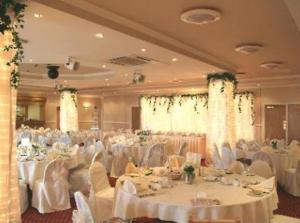 a banquet hall with white tables and white chairs at Southview Park Hotel in Skegness +115 photos