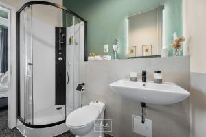 a bathroom with a sink and a toilet and a shower at Art Apartments in Hamburg