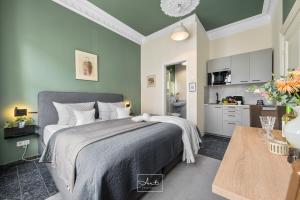 a bedroom with a large bed and a kitchen at Art Apartments in Hamburg