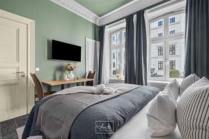 a bedroom with a bed and a desk and a window at Art Apartments in Hamburg +117 photos