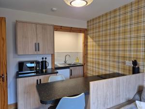 a kitchen with a counter top and a microwave at The Studio in Drumnadrochit