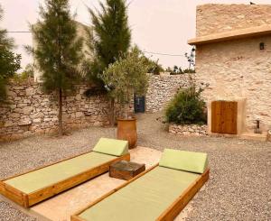 two beds sitting on the ground next to a building at Idyllic lodge in Essaouira