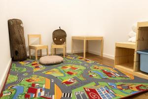 a room with two chairs and a rug on a floor at Apartmány Deštné 251 in Deštné v Orlických horách