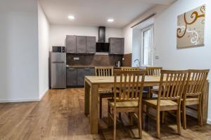 a kitchen with a wooden dining room table and chairs at Apartmány Deštné 251 in Deštné v Orlických horách