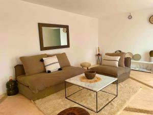a living room with a couch and a table at Idyllic lodge in Essaouira