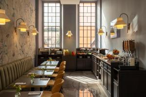 a restaurant with tables and a kitchen with windows at Hotel Viminale in Rome +69 photos