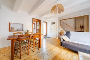 a living room with a table and a couch at Maison avec jardin in Chirac