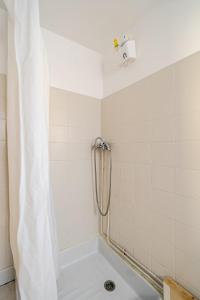a shower with a shower curtain in a bathroom at Maison avec jardin in Chirac +4 photos