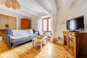 a living room with a couch and a flat screen tv at Maison avec jardin in Chirac