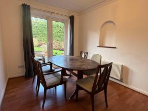 a dining room with a table and chairs and a window at Large 4 Bed with Parking in Hillmorton