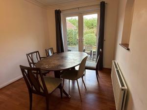 a dining room with a table and chairs and a window at Large 4 Bed with Parking in Hillmorton
